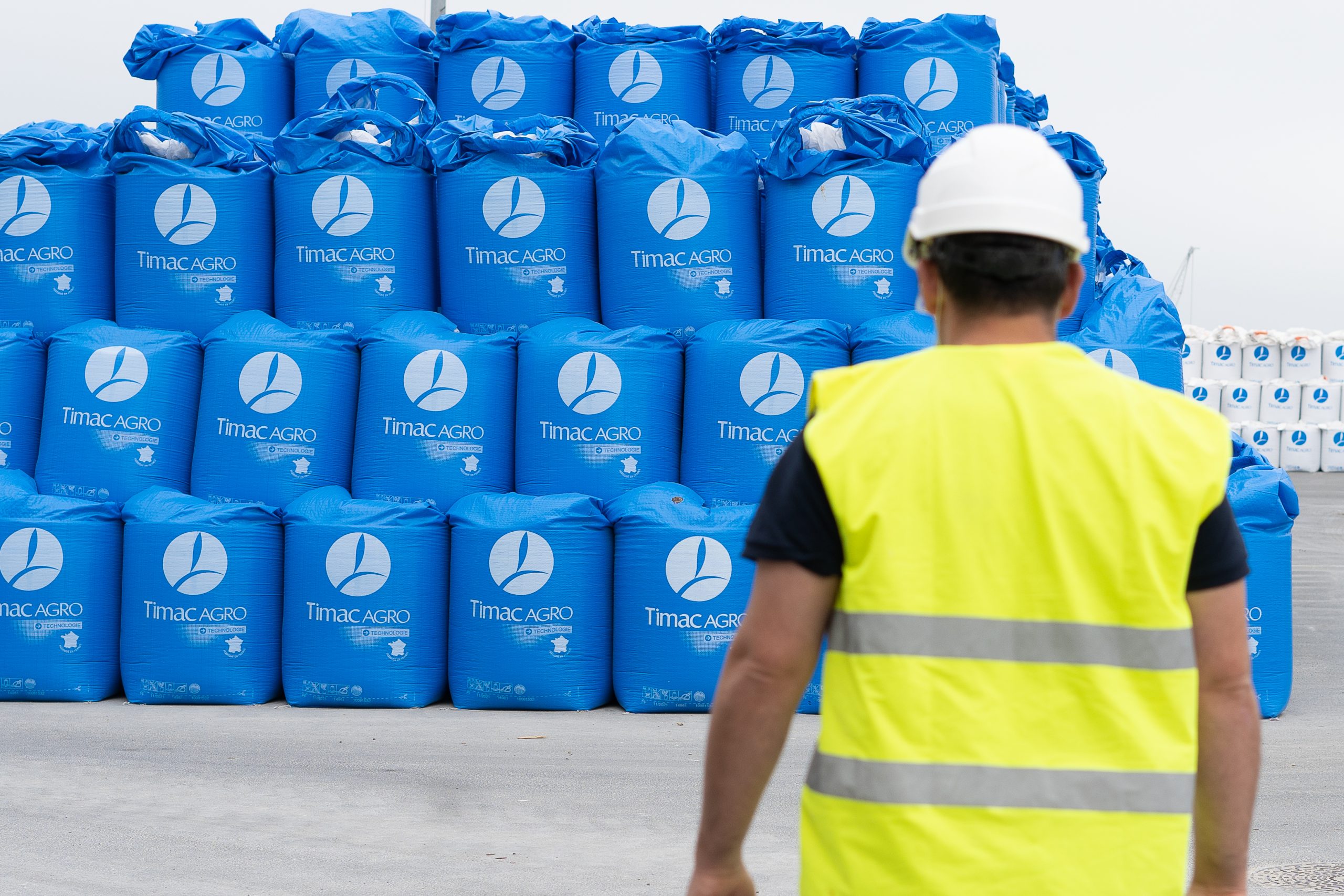 big-blue-fertiliser-bags-human